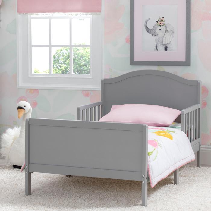 A gray Bennett Toddler Bed with guardrails on both sides, displayed in a room with a wall painting of an elephant and a swan.