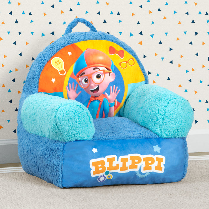 A blue plush chair with a colorful Blippi character design, featuring a handle and super-soft sherpa detailing.