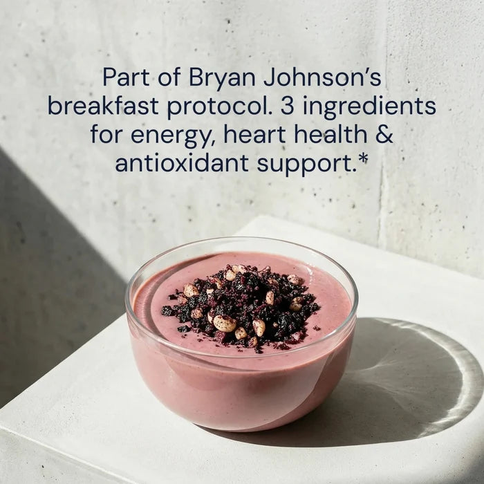 Pink smoothie bowl with toppings on a white surface, text about Bryan Johnson's breakfast protocol.