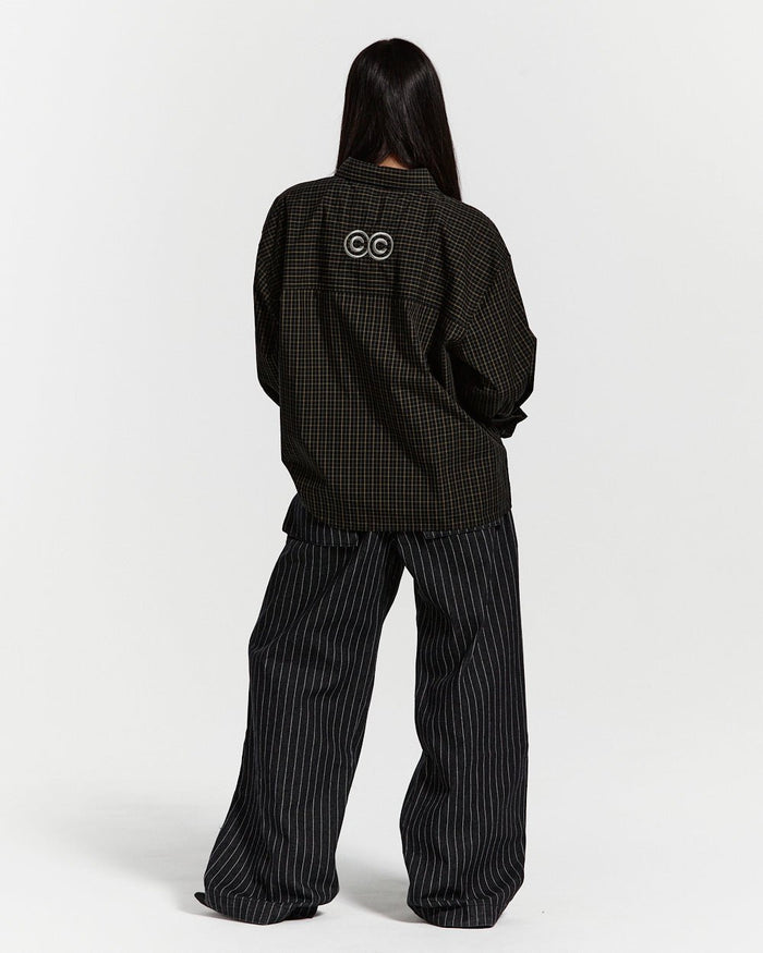 CASINO PANTS BLACK DENIM - black pinstripe denim pants, back view on female model - Cold Culture