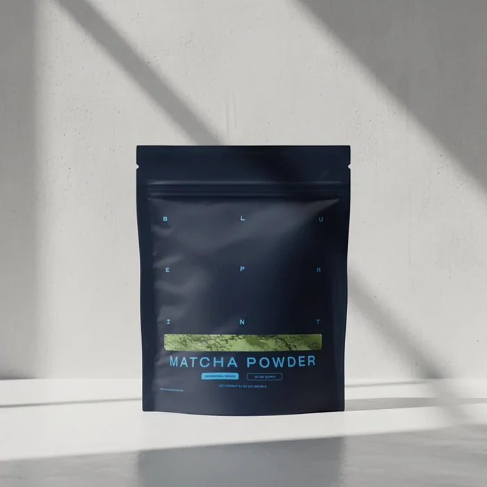 Dark blue package of matcha powder on a light gray background