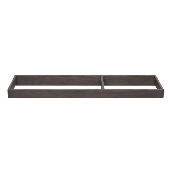 A brown wooden changing top designed to be attached to a dresser, featuring a smaller compartment and a felt bottom.