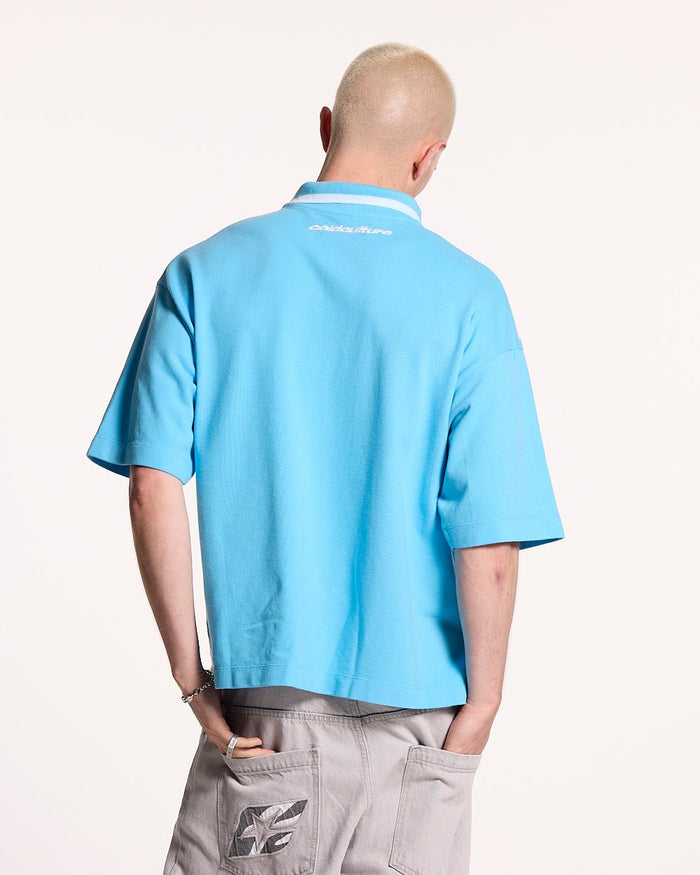 COCKY POLO BLUE - blue graphic print polo shirt, back view on male model - Cold Culture #man