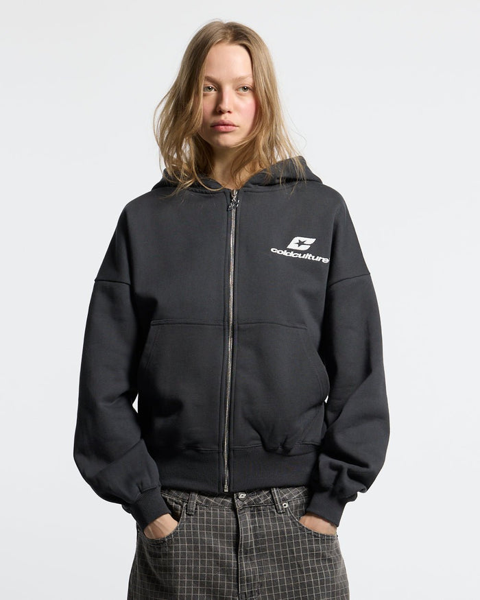 CURVED ZIP HOODIE INDIA INK - black logo print zip hoodie, front view on female model - Cold Culture #woman