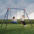 Two children sitting on a two-piece metal swing set with one swing seat and one disc/saucer swing, located outdoors on a grassy field.