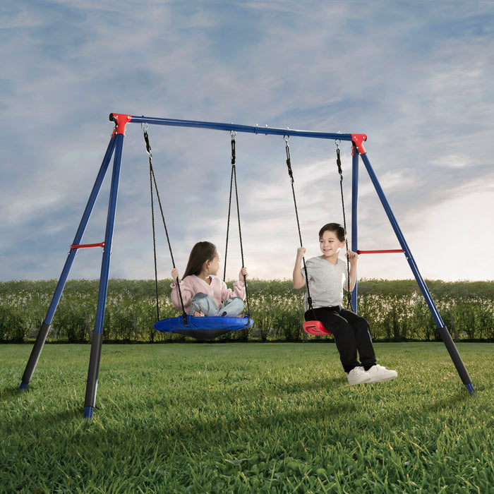 Two children sitting on a two-piece metal swing set with one swing seat and one disc/saucer swing, located outdoors on a grassy field.