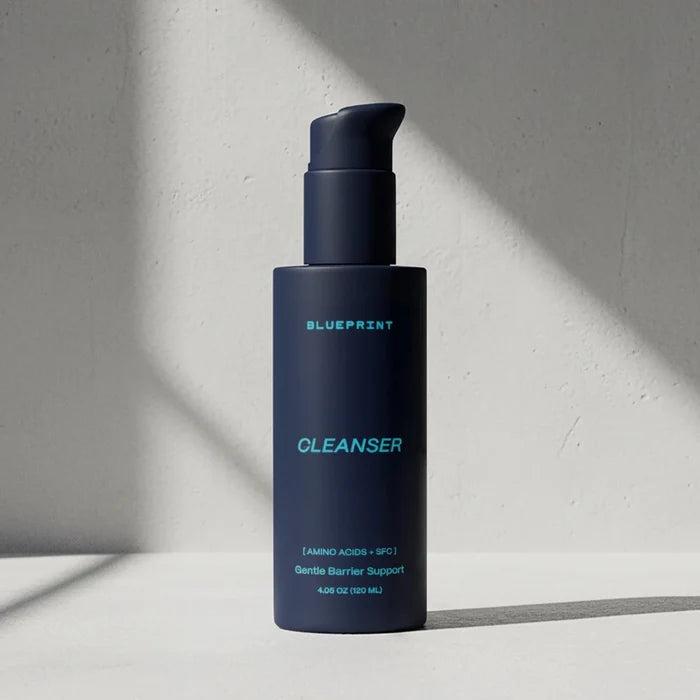 Blue bottle of Blueprint Cleanser on a light gray background