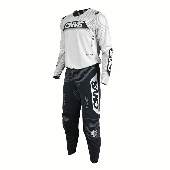 Motocross outfit with white top and black pants featuring 'CNVS' branding on a white background.
