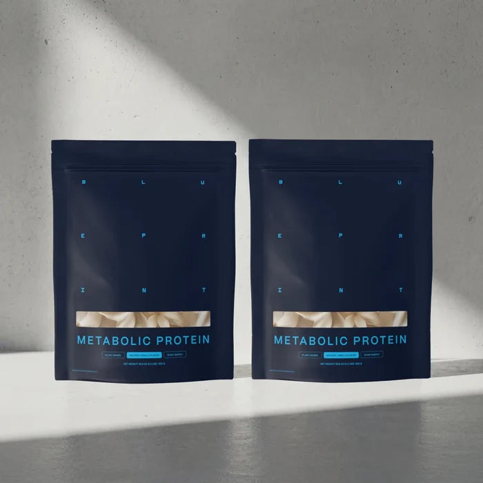 Two packages of Metabolic Protein on a gray surface with a light gray background #vanilla_30-day
