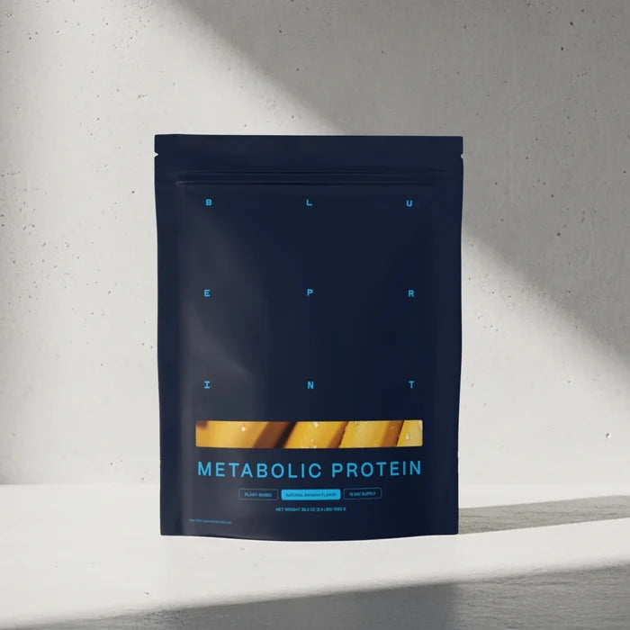 Dark blue package of Metabolic Protein on a light gray background #banana_15-day