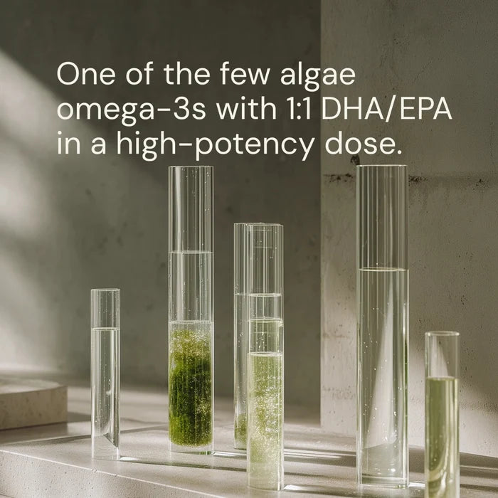 Clear glass vials with green algae extract on a neutral background