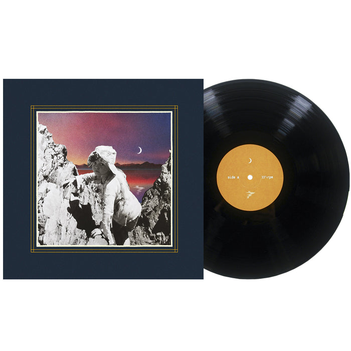 A vinyl record next to its cover, which features a classical statue among rocky mountains with a crescent moon in a colorful dusk sky, as distant galaxies shimmer above the serene landscape.