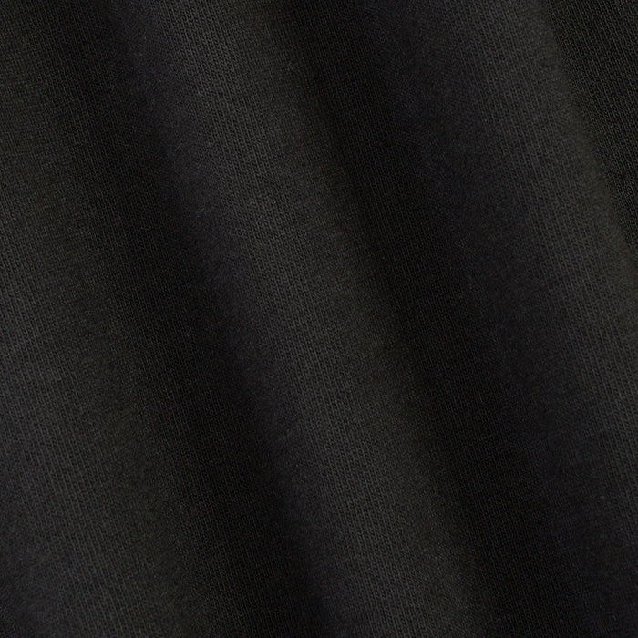 A close-up of dark charcoal gray knit fabric with soft folds showing the fine ribbed texture.