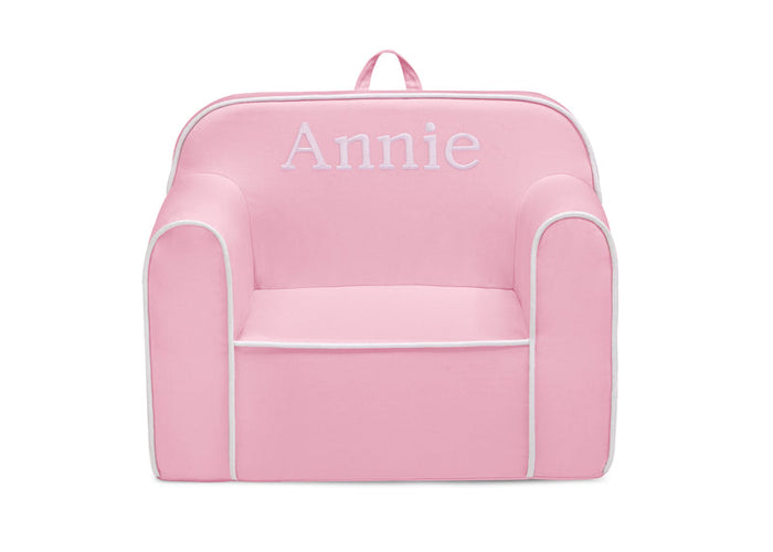 Pink children's chair with 'Annie' embroidered on a white background