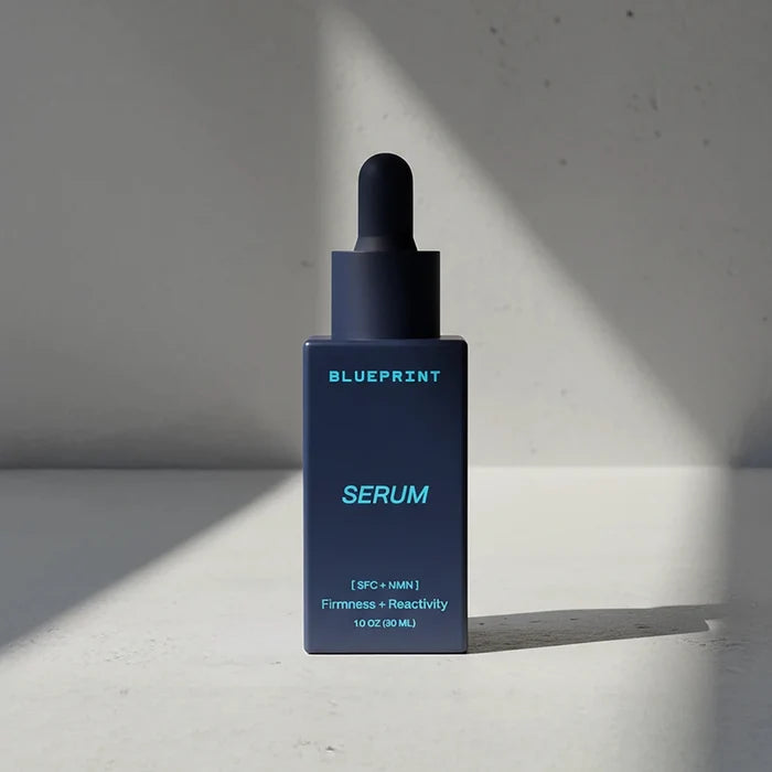 Blue serum bottle with dropper labeled 'Blueprint' on a light gray background