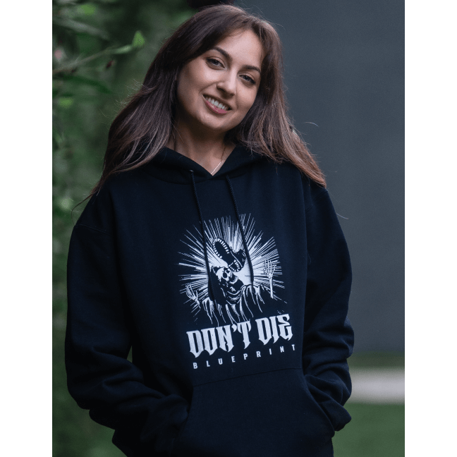 Lifestyle image of girl wearing Skull Kick Hoodie