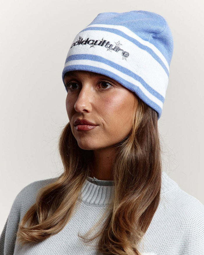 STARS STRAP BEANIE BLUE CALICO - blue striped knit beanie, front view on female model - Cold Culture