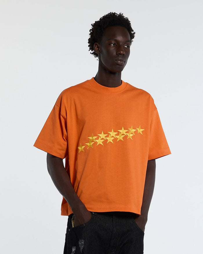STARS TEE VIBRANT ORANGE - orange star print tee, front view on male model - Cold Culture