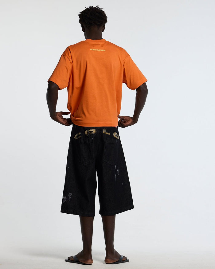 STARS TEE VIBRANT ORANGE - orange star print tee, back view on male model - Cold Culture