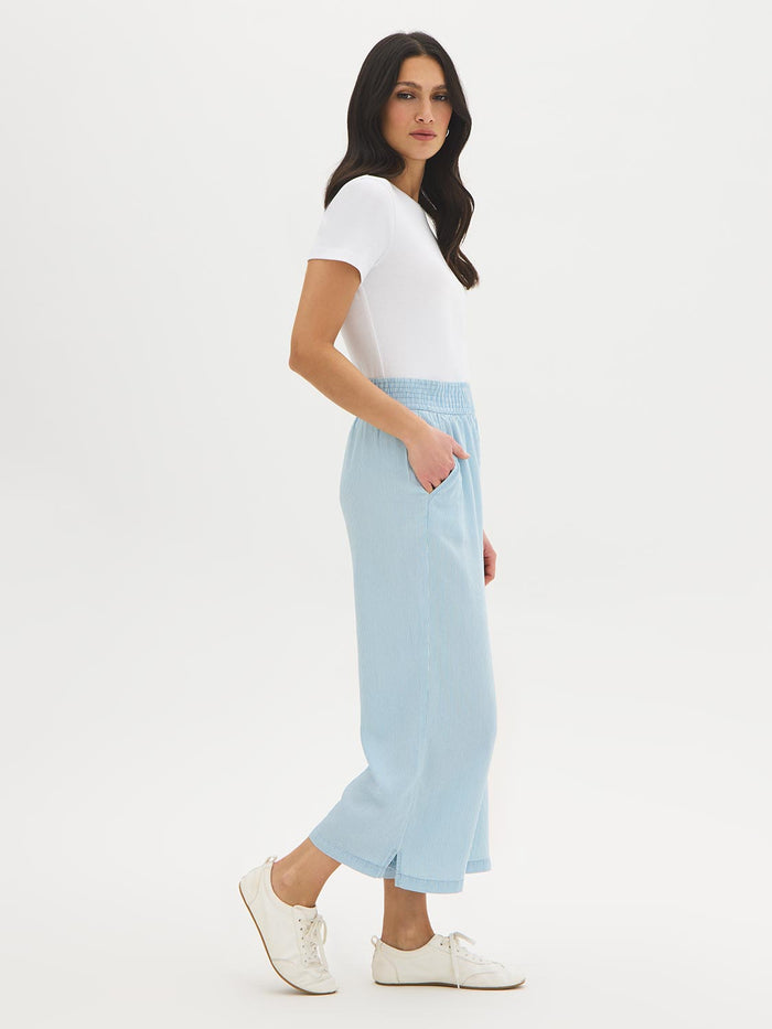 Light Wash Stripe Denim Tencel Gaucho Pant - Woman Wearing Wide-Leg Pants with Smocked Waistband - Suzy Shier