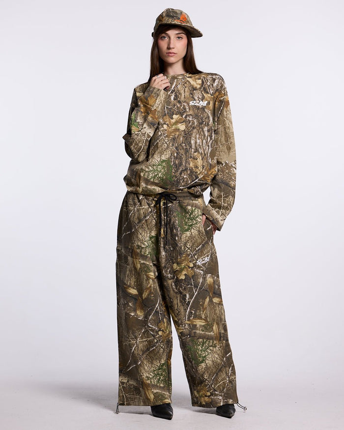 SWEATPANTS REALTREE EDGE - brown camo sweatpants, front view on female model - Cold Culture #woman