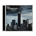 A CD cover for I Am Abomination features a dark, rain-soaked city skyline with an eerie eye near the top of the tallest building. The brand name "I Am Abomination" and the album title "Invisible Titans" are displayed in white at the top left.