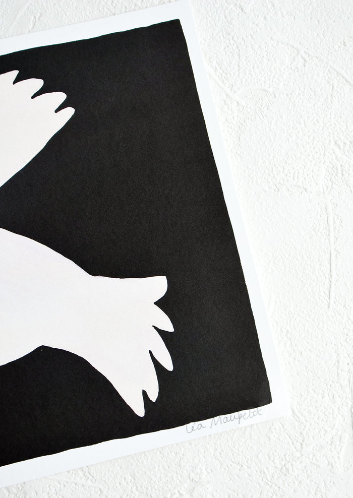 Artist's signature on corner of black and white art print.