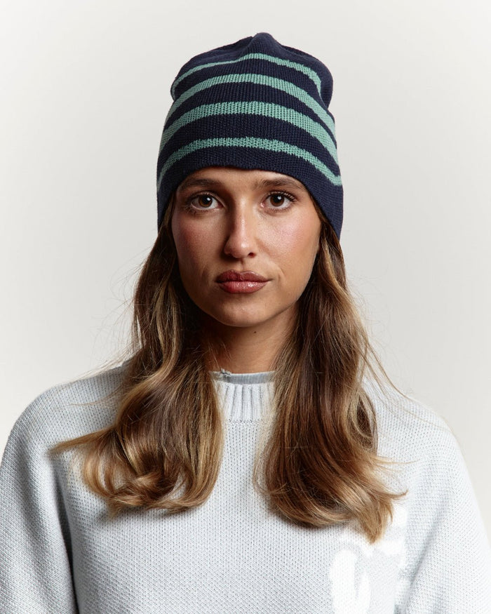 WORK BEANIE HEAVY BLUE - navy blue striped knit beanie, front view on female model - Cold Culture #woman